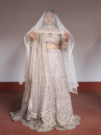 A classic bridal party pose with the dupatta as a veil, showing the versatility of this beautiful rental outfit.