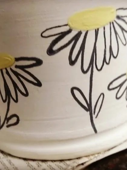 A glimpse of the simple joys of paint-your-own-pottery. You can pick a pre-made piece, like this mug, and let your creativity flow by painting a design that is uniquely yours.