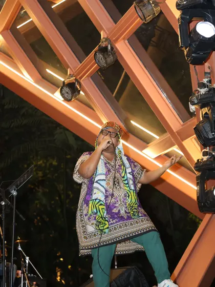 I don't lose myself in women; I find rhythm in the chaos and sing them back their worth. A powerful stance on stage, connecting with the audience.