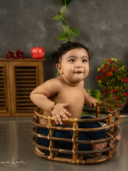 A cheeky grin from inside a basket. This baby's personality shines in this rustic, farm-inspired milestone session.
