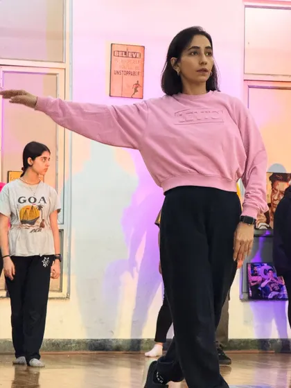A student holding a pose with grace. Our classes blend different styles, including elements of jazz and commercial dance.