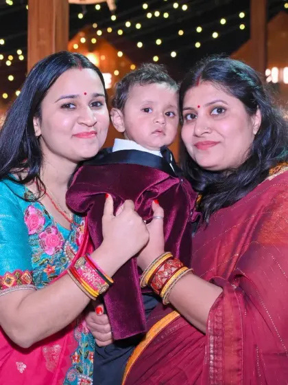A group portrait of family members with a young child, taken during an evening event.