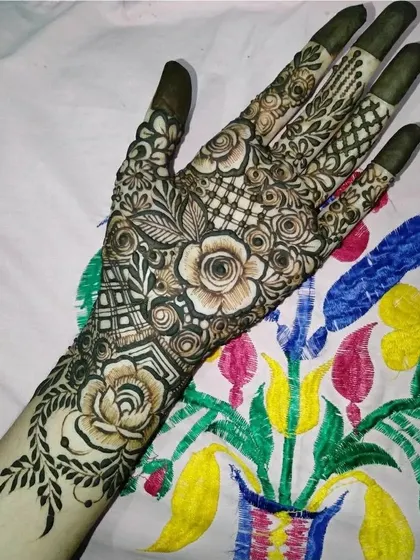 A beautiful full-hand design with a mix of negative space and detailed rose and net patterns.