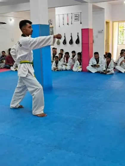 Senior and junior students practicing forms together.