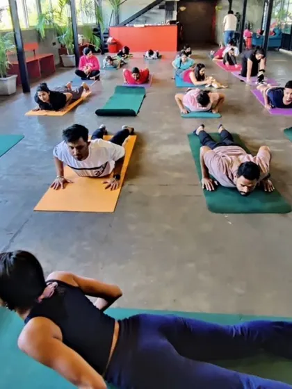 Guiding a class through Bhujangasana, or Cobra Pose. This heart-opening asana helps build strength in the spine and stretch the chest.