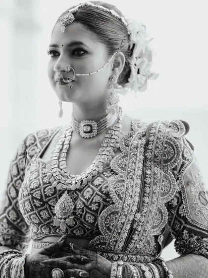 A stunning black and white portrait focusing on the bride's regal jewelry and confident gaze.
