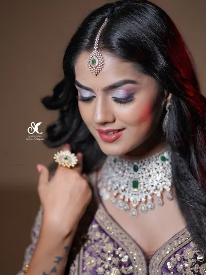 A close-up portrait focusing on the stunning diamond necklace and colorful eye makeup. This shot is perfect for showcasing the work of makeup artists and jewelers.