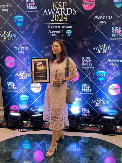 A proud moment with my award. This recognition fuels my passion to continue capturing beautiful, timeless memories for families.