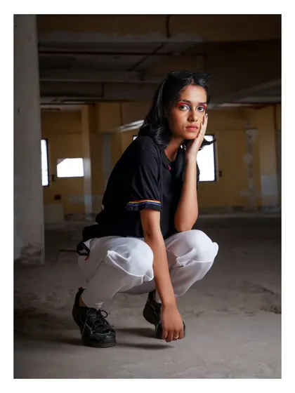 An edgy, urban portrait from the "No Label" campaign. The raw, industrial setting and the model's direct gaze create a powerful statement.