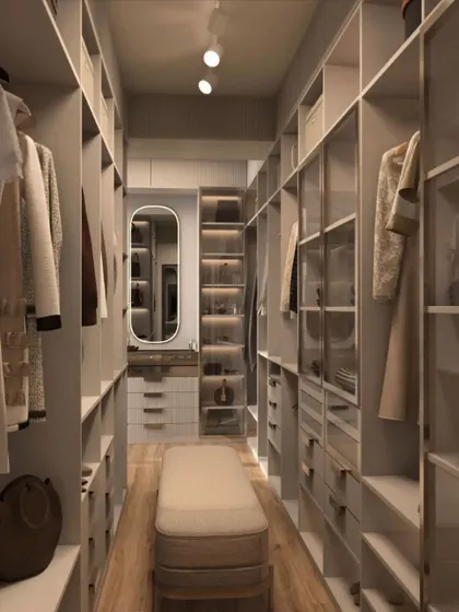 This walk-in closet uses a mix of open storage and glass-front drawers. This allows you to see your accessories at a glance while keeping them protected from dust.