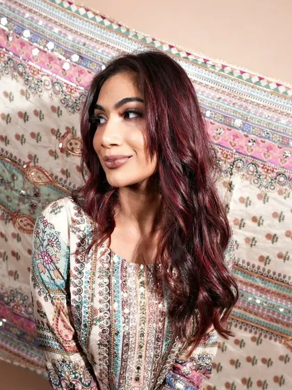 Another elegant portrait of our client, with her custom red hair beautifully complementing the intricate patterns of her attire.