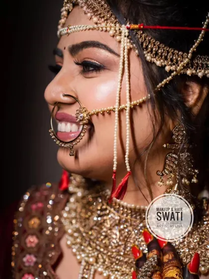 A side profile showcasing Henoy's intricate bridal jewellery and the flawless makeup application by Swati.