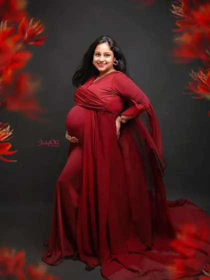 This mama-to-be is all smiles and she looks absolutely radiant. The rich red of her gown stands out beautifully against the dark, classic backdrop.