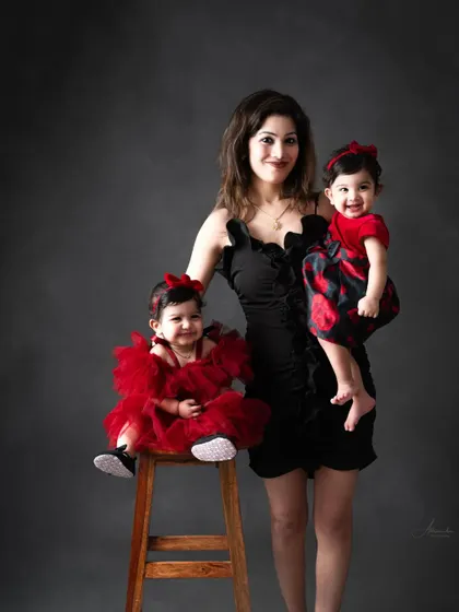 A mother's arms full of love with her two twin daughters. A beautiful and strong portrait.