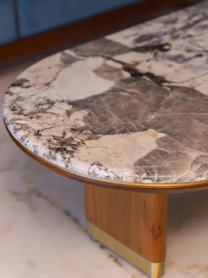This beautiful center table, with its unique Brazilian marble top and sculptural wooden base, is designed to be a charming and functional centerpiece for any living room.