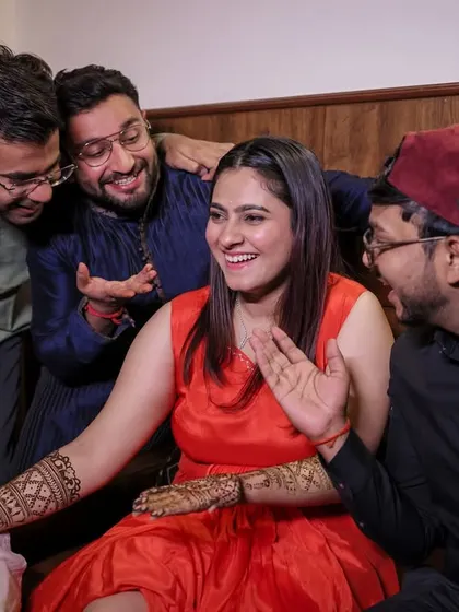 The bride sharing a laugh with her friends and family as they admire her Mehandi. Capturing these group dynamics is key.