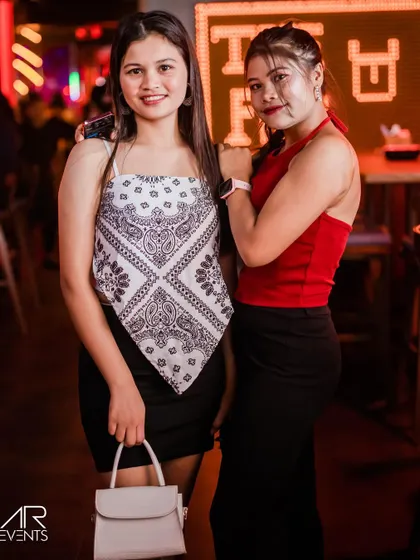 Two friends showcasing their individual styles at The Fixx.