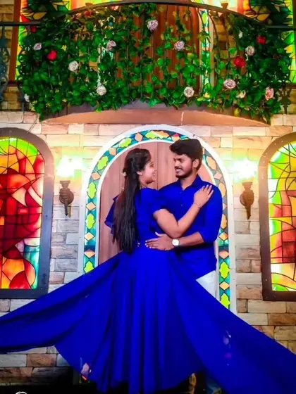 A couple embraces in a colorful doorway, with the long trail of our royal blue flying dress creating a beautiful frame.