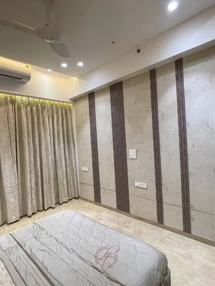 This bedroom design uses a combination of textured wallpaper and wood-look panels to create a warm and inviting atmosphere. The simple, clean lines ensure a minimalist and clutter-free feel.