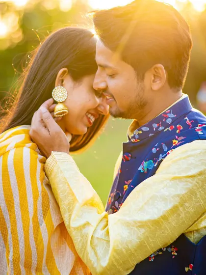 A close-up of a sweet, candid moment during a golden hour pre-wedding shoot. It’s these genuine smiles and gentle touches that make the best photographs.