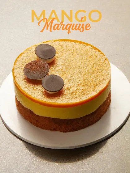 The Mango Marquise, an elegant layered dessert featuring mango mousse and a light sponge base. A sophisticated way to enjoy the king of fruits.