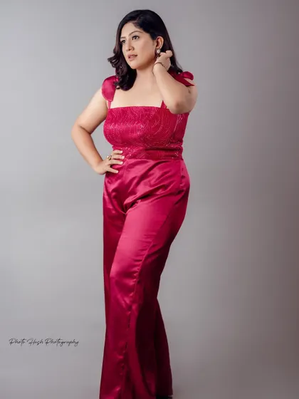 A confident pose showing off the full outfit and soft, wavy hair.