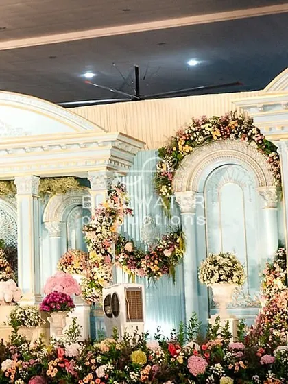 A closer look at the intricate floral work on the 'Blue Palace' stage, where blooms were placed to complement the architectural details without overwhelming them.