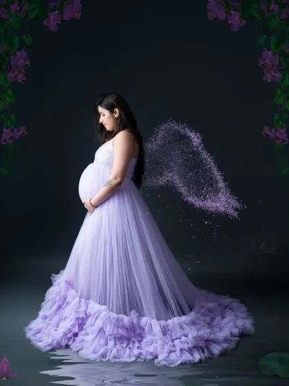 An angelic portrait for a magical time. We added a touch of creative editing to this lavender gown photo to give the mom-to-be beautiful, sparkling wings.