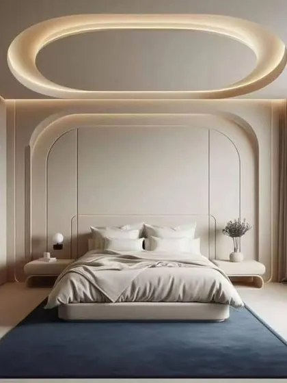 This bedroom design is all about clean lines and soft curves. The arched wall panels and oval false ceiling create a minimalist yet visually interesting space.