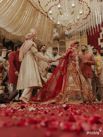 The seven sacred steps, or Saptapadi, are the foundation of the marriage. I create a path of scattered rose petals for this ritual, symbolizing a beautiful and fragrant journey ahead, all under a canopy of cascading floral strings.