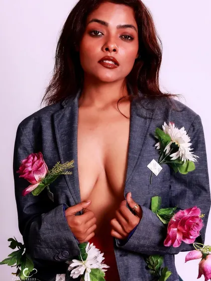 An intimate and alluring portrait that invites the viewer to look closer at the details of the floral blazer.