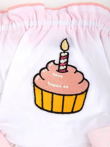 A macro shot of the sequined cupcake and candle embroidery.