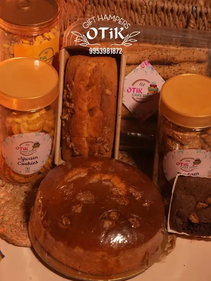 A generous Diwali hamper overflowing with a variety of my baked goods, including a large walnut cake, dry cake, brownies, and multiple jars of cookies.