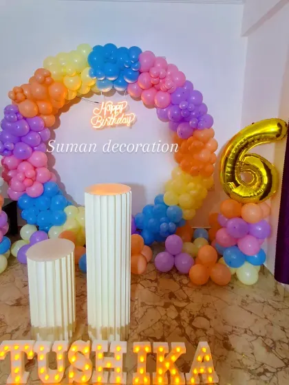 The complete unicorn setup with the birthday girl's name 'Tushika' in large marquee letters in the foreground.