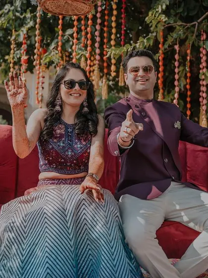 A playful pose from the couple during their mehendi. Their energy and smiles are infectious, perfectly capturing the celebratory mood of the day.