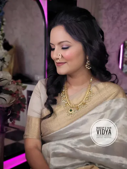 A serene and beautiful festive look. The soft lighting highlights the beautiful makeup and traditional nath.