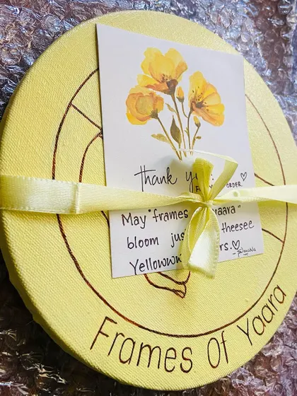 The logo hand-painted onto a round canvas, packaged with a thank you note for the client.