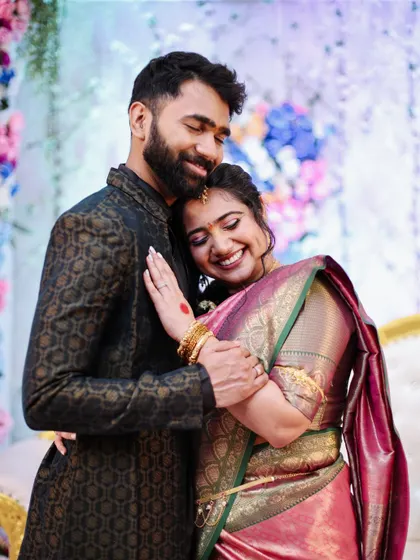 A tender moment captured as a couple embraces after their engagement.