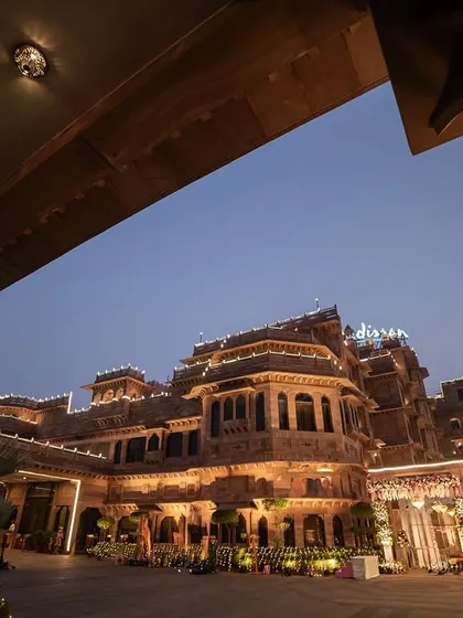 The grandeur of a palace wedding venue lit up at dusk. We don't just photograph people; we capture the entire atmosphere, ensuring the scale and beauty of your destination wedding are part of your story.