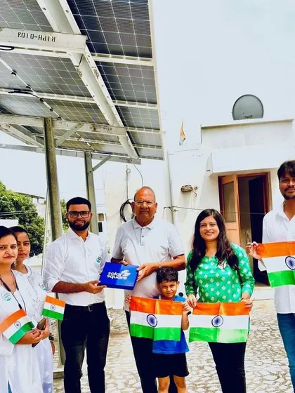 A family celebrates their new solar-powered home with our team. We believe every solar home makes India stronger and more self-reliant.