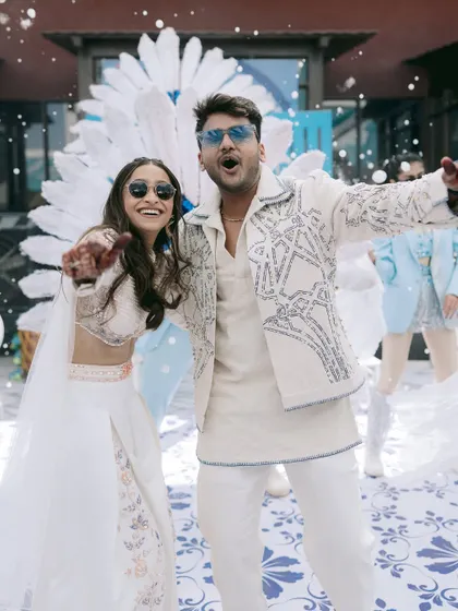 A moment of pure fun and celebration. The couple's energetic poses and the "snow" effect make this a lively and memorable shot from their Balotra wedding festivities.