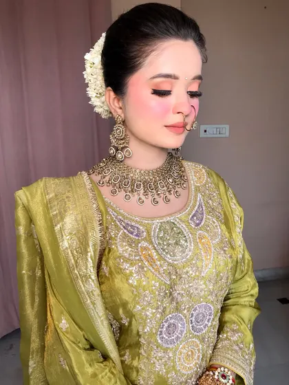 A side view showing the elegant bun adorned with a fresh white gajra, a classic touch for any traditional look.