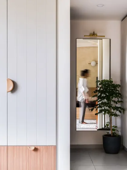 A view of the master wardrobe from the hallway, showing how the clean lines and two-tone design integrate seamlessly with the rest of the home.