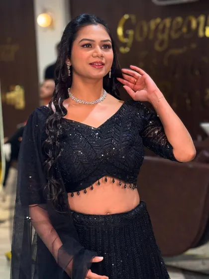 This is a great example of my HD party makeup. We created a fresh, glowing look with defined eyes and a natural lip color that perfectly complements her sparkling black lehenga. It's a glamorous yet comfortable style, ideal for a sangeet, cocktail night, or reception party.