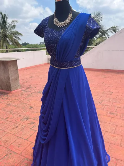 A royal blue draped gown with a sequined bodice.