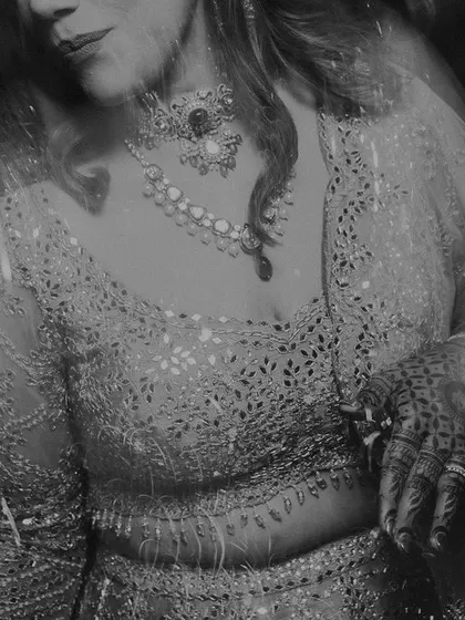 A beautiful, moody black and white portrait of the bride, with a soft blur effect that adds to the glamour and mystery of the night.