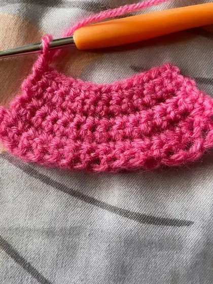 This piece shows a student practicing how to increase stitches to create a curved shape. This is a fundamental skill for making everything from hats to amigurumi toys.