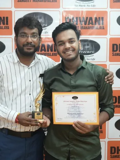 A teacher and his student share a moment of success.