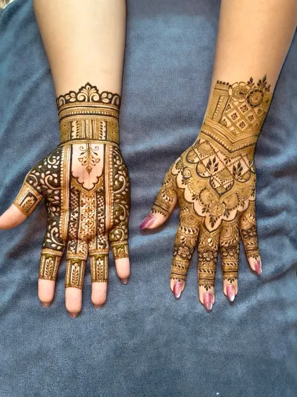 The complete bridal look. One hand features a geometric, architectural style, while the other has a more organic, flowing design, showing how we can play with different themes.