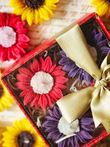 A gift box of mixed-color sunflower floating candles, tied with a beautiful ribbon. This is a popular choice for Diwali gifting, offering a complete and beautiful decor solution.